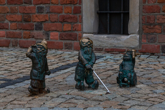 Wroclaw, Poland - September 13, 2017: A picture of three gnomes with different disabilities as seen in Wroclaw.