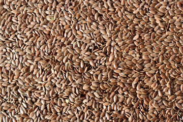 
Flax seeds . Brown background from seeds. Close-up. Horizontal photo.