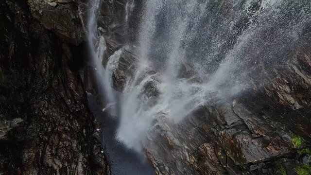 Steady drone footage at the bottom of a waterfall. Southern Norway