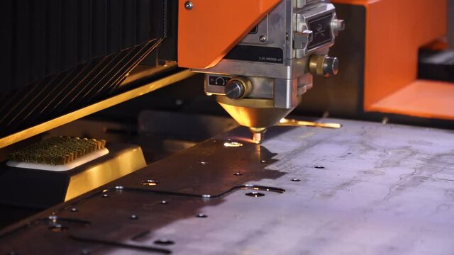 Fiber laser cutting CNC machine cuts metal list close-up. Making metal part.