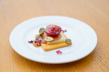 Cracker with cheese, honey and grapes close-up.  Decorated catering banquet menu with different food snacks and appetizers with sandwich.