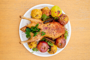Chicken baked with apples decorated with spices top view.