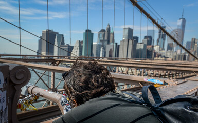 Photographer young Woman Taking photos of Manhatan sky line from Brookline Bridge 
