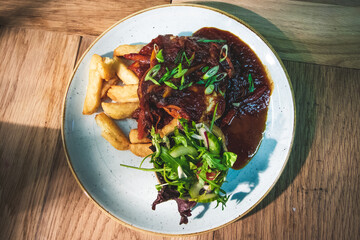 Pan fried chicken breast covered in a sweet chilli sauce, served with a side salad and triple cooked chips, garnished with spring onions and chilli.