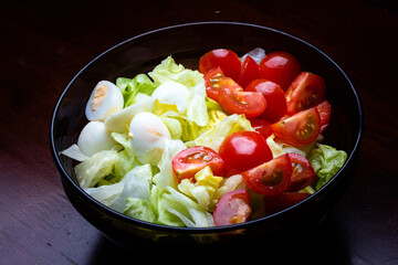 Caesar salad in a dark glass salad bowl