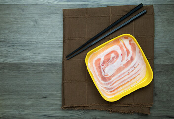 fresh raw pork, meat ,beef, belly, sliced on square plate  on wood, wooden background,set shabu, hot pot ingredients.