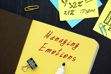Business concept meaning Managing Emotions with sign on the piece of paper.