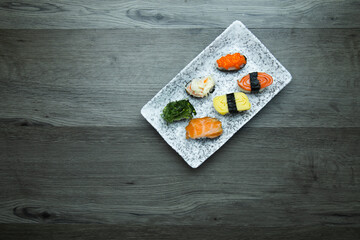 Sushi Set sashimi and sushi rolls served on wood background