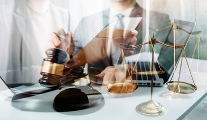 Business and lawyers discussing contract papers with brass scale on desk in office. Law, legal services, advice, justice and law concept picture with film grain effect