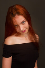 Fototapeta premium portrait of a beautiful red haired young positive woman in studio