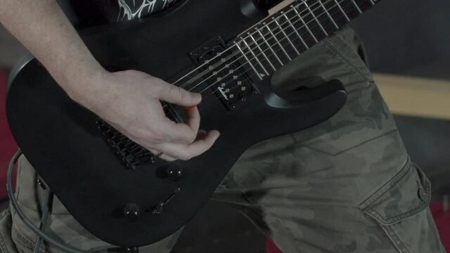 close up Heavy metal Guitarist playing on his guitar - slow motion