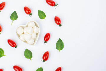Mozzarella cheese, cherry tomatoes and basil leaves in composition