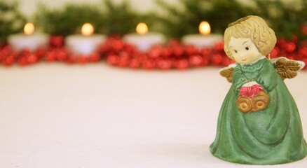 Christmas angel green red candels background 