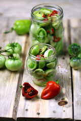 Green tomatoes are pickled in jars. Fermentation of tomatoes. Probiotics.