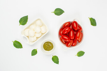 Mozzarella cheese, cherry tomatoes and basil leaves in composition