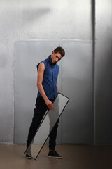 Portrait of a handsome stylish sporty man. Photo for business. Beautiful posing.