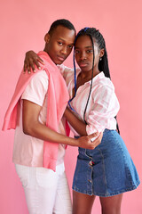 confident married couple of african appearance hug each other isolated on pink background, love and relationships concept