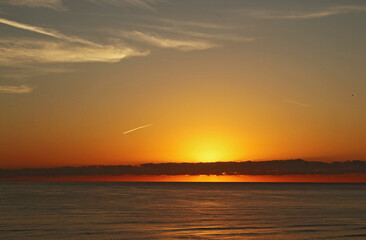 Fototapeta na wymiar Yellow and red sunrise on the beach, sea landscape