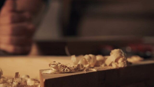 Carpenter working with jointer on wooden block