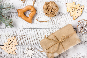 Merry christmas concepts with gift box, pastries and ornament element on white wooden table background with copy space