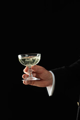 Person holding a glass of champagne