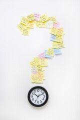 Wall clock with notes in shape of question mark