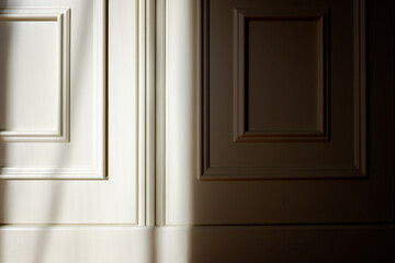 Shadows and sun rays outline a  white wooden door with a skilled carpenter.