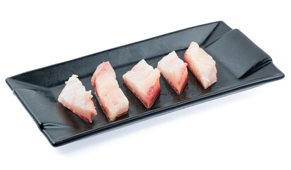 fresh raw fish sliced on square plate isolated on white background, shabu, hot pot ingredients