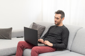 Man working on his laptop pc at home
