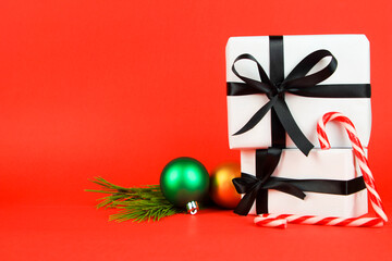 Gifts with Christmas decoration on red background
