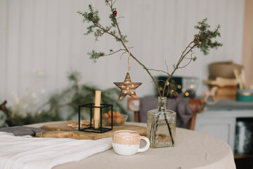Festive Christmas home. Table setting with rustic decorations for Christmas. New Year decorations in modern interior design