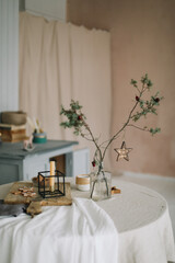 Festive Christmas home. Table setting with rustic decorations for Christmas. New Year decorations in modern interior design