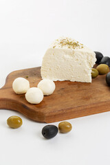 Feta cheese and olives on white background