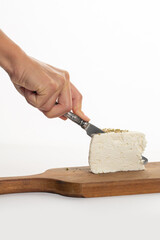 Woman cut white cheese on white background