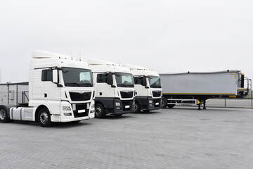 Trucks with cargo trailers in the parking lot, Freight transport by road, Logistics and transport
