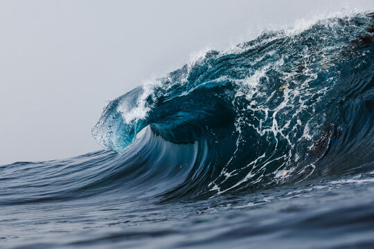 Powerful blue breaking ocean waves with white foam