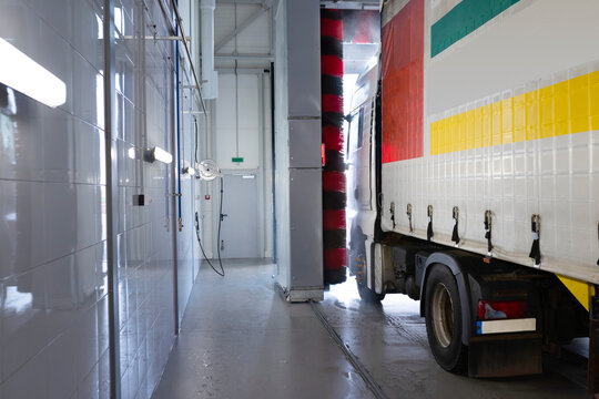 Truck at a car wash using high pressure water with detergents. Keeping trucks clean. Car service