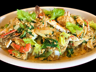 Close up of blue crab dish with yellow curry sauce mix with eggs, curry plate, fish sauce, palm sugar, chili, onion, green celery, one of the most delicious seafood in Thailand.    