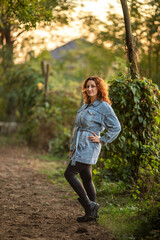 young beautiful girl in denim jacket on farm