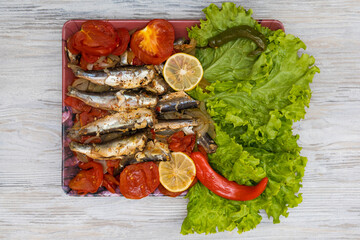 Fish stewed in vegetables with lemon. Culinary background with selective focus