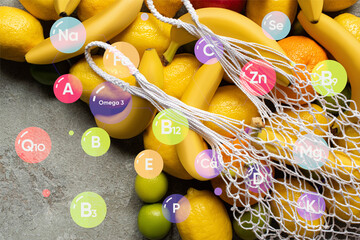 top view of colorful fruits and string bag on grey concrete surface, vitamins illustration