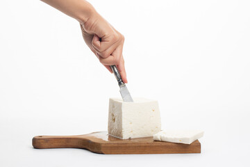 Woman cut white cheese on white background