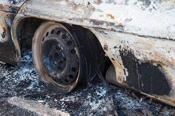 Burned down car, abstract background, selective focus. The situation of protests in the world.