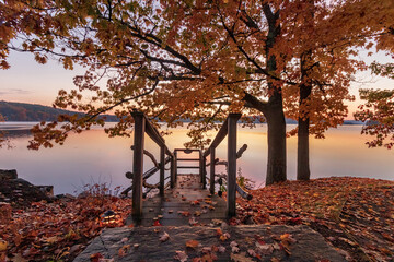 sunrise on the lake with dock in fall 