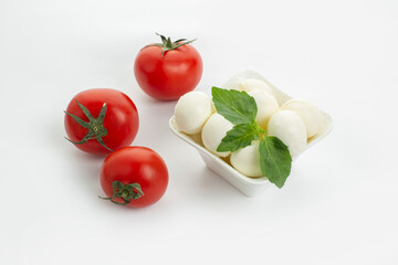 Mozzarella cheese, cherry tomatoes and basil leaves in composition