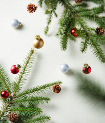 Christmas yellow background with fir branches, cones and Christmas toys