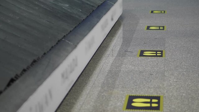 footprint signs. social distancing. yellow markings on the floor to maintain social distance between people during coronavirus epidemic. close-up. at the airport. New restrictive measures due covid-19