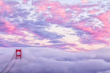 Scenic view of Golden Gate Bridge covered with fog during sunset