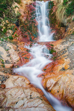 Scenic View Of Waterfall Flowing From Mountain