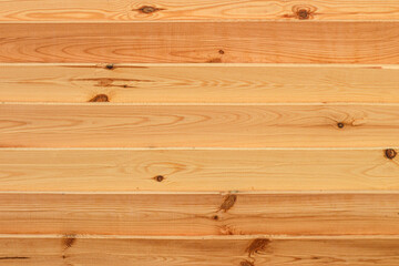 Texture of fresh wooden boards. Horizontal planks shield. Rough sawn pine boards stack on the construction site